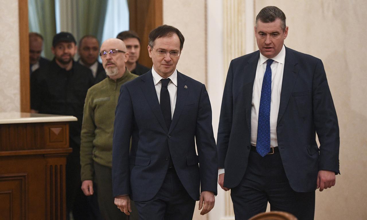 Russian Presidential Aide Vladimir Medinsky, left, and Russian State Duma member Leonid Slutsky, followed by the Ukrainian delegation arrive for Russian-Ukrainian talks in Belarus on February 28.